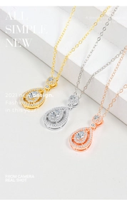 Detailed view of pear-shaped diamond pendants in gold, silver, and rose gold finishes