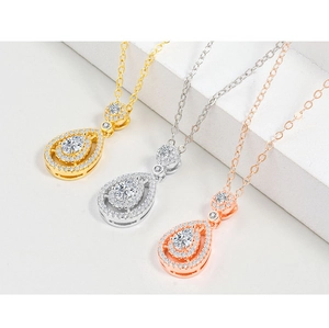 Close-up of pear-cut pendant necklaces in gold, silver, and rose gold finishes