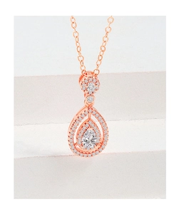 Detailed macro of a rose gold water drop pendant necklace with sparkling halo crystals