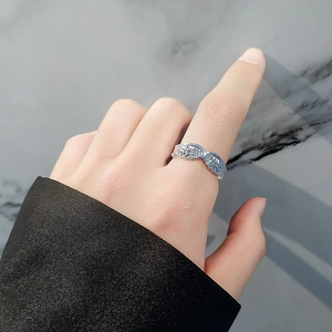 Silver angel wings open ring with pavé micro-diamonds shown on a finger