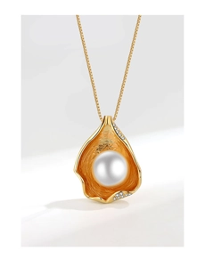 Detailed macro view of irregular gold petal pendant with imitation pearl and zircon accents