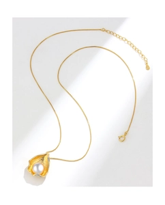 Detailed view of S925 shell pendant with pearl and tiny diamonds on gold necklace