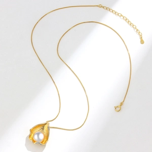 Golden irregular shell pendant necklace with white pearl and S925 chain on white surface