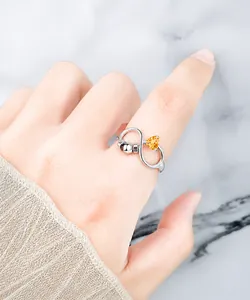 Detailed close-up of S925 sterling silver anti-anxiety ring with heart-shaped orange stone