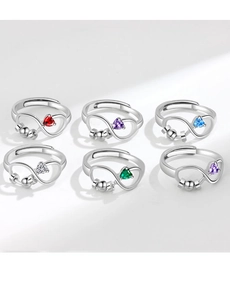 Detail of adjustable silver infinity rings featuring spinning beads and colorful zircons