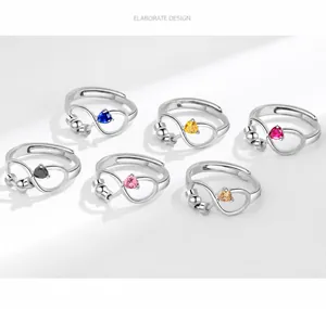 Detail of adjustable silver rings with heart stones and moving anti-anxiety beads