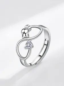 Detail of adjustable spinner ring with moving bead and heart-shaped cubic zirconia