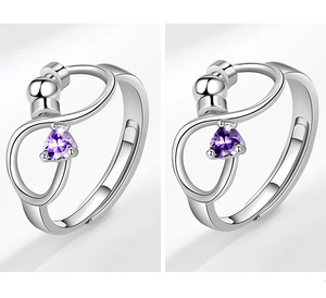 Close-up of S925 sterling silver infinity fidget ring with purple pear-shaped gemstone
