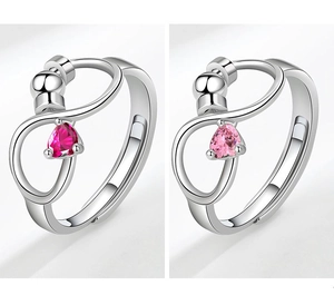 Macro detail of infinity ring featuring heart-cut zircon and sliding metal beads