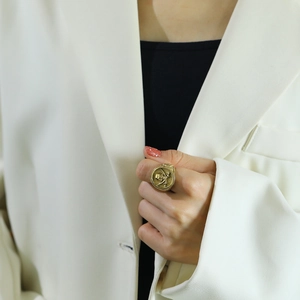 Vintage punk skull and crossbones ring in 18k gold finish worn on finger