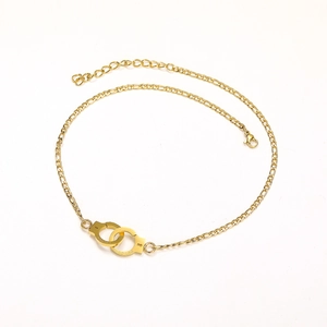 Detail of gold handcuff pendant necklace with UNLOCK and PUT DOWN engraving and lobster clasp