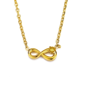 Macro shot of 18k gold plated infinity pendant with a sparkling yellow gemstone