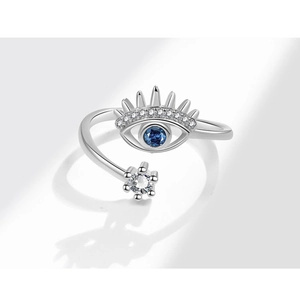 Macro detail of adjustable Evil Eye ring with blue gemstone and sparkling zircon accents