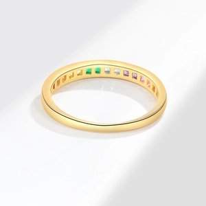Luxurious gold ring with rainbow baguette zircon stones in a seamless pave setting