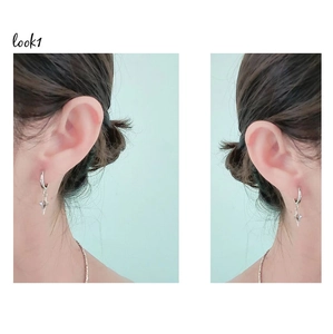 Gros plan montrant les boucles d'oreilles étoile argentées pour souligner la texture lisse