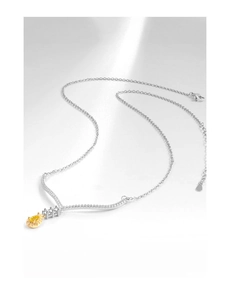 Macro detail of pear cut yellow gemstone pendant with S925 silver lobster clasp chain