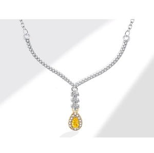 Macro detail of pear-cut yellow gemstone necklace with sparkling diamond-set V-shape
