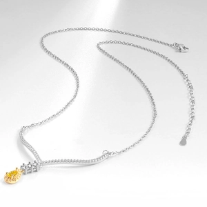 Elegant silver necklace featuring a pear-cut yellow gemstone pendant with diamond halo