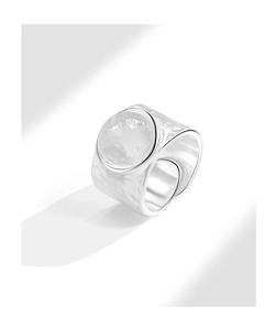 Close-up of hammered silver ring featuring a large translucent white crystal gemstone