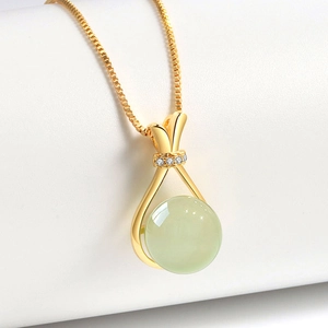 Elegant gold fortune bag necklace with green faux jade pendant and sparkling crystals