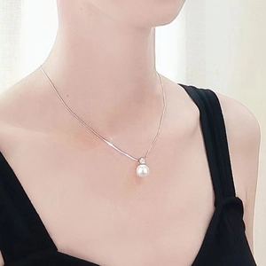 Elegante witte ronde parelhanger met diamant aan een fijne zilveren ketting