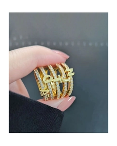 Close-up of a multi-layer gold-plated ring with inlaid zircons and ADLIN lettering