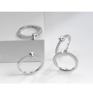 Macro shot of silver adjustable rings featuring micro-pave zircon letters P, R, E, T