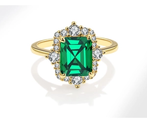 Macro detail of emerald-cut green gemstone ring with white zircon halo and gold band