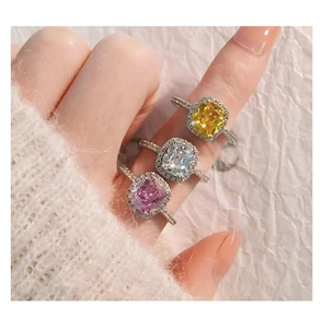 Detailed close-up of three cushion cut halo rings in yellow, white, and purple colors