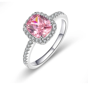 Macro shot of cushion cut pink gemstone ring with halo diamonds and white gold band
