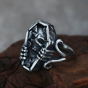Detail of gothic stainless steel coffin skull ring featuring intricate rose engravings
