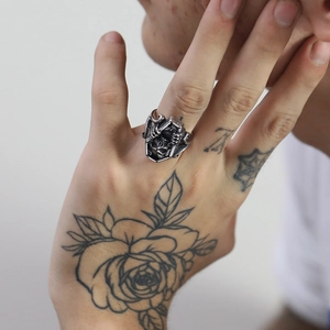 Macro detail of retro gothic skull coffin ring in distressed silver finish for men