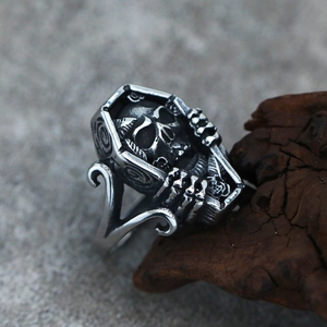 Macro detail of gothic skull coffin ring in vintage oxidized titanium steel finish