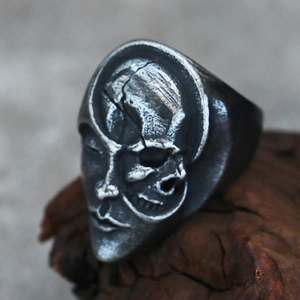 Detailed macro view of vintage gothic skull mask ring in punk style with aged silver finish