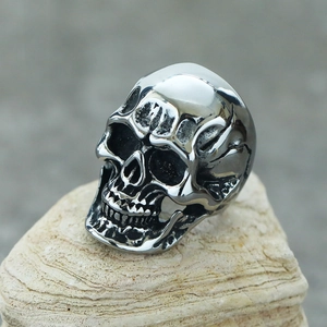 Macro detail of gothic skull ring with vintage steel finish on stone background
