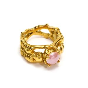 Gothic punk skull ring in gold finish featuring a central round pink gemstone inlay