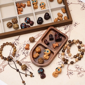 Macro detail of hand-carved sandalwood snake beads and textured wooden craft ornaments