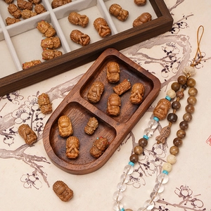 Hand-carved wooden Buddha beads and Buddhist prayer necklace on a Zen style background