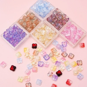 Macro shot of colorful gradient flower glass beads in plastic organizers for DIY jewelry