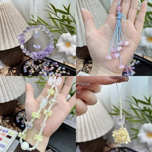 Detailed view of handmade gradient glass flower beads and charms for DIY jewelry making