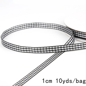 Detail shot of 1cm wide black and white gingham ribbon roll for gift wrapping