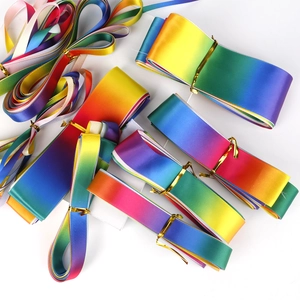 Close-up of rainbow gradient polyester ribbons with glossy silk texture and gold ties
