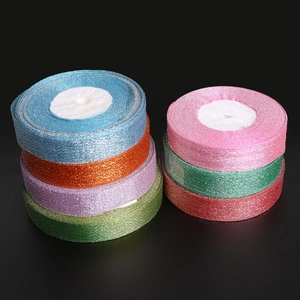 Close-up of glitter ribbon rolls in assorted colors for festive gift packaging and crafts
