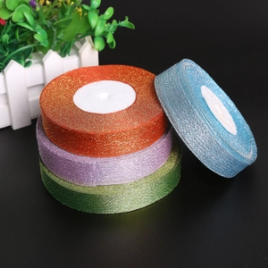 Close-up of sparkling glitter ribbons in gold, purple, green, and blue for gift wrapping