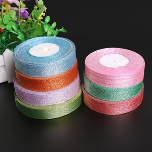 Close-up of sparkling glitter ribbon rolls in 7 vibrant colors for gift wrapping