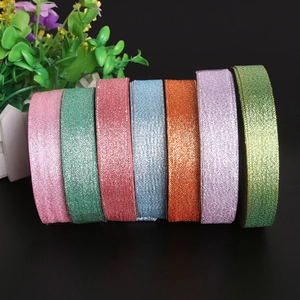 Close-up of seven assorted glitter ribbons for Christmas gift and flower box packaging