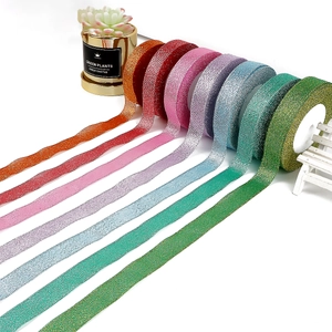 Glitter shimmering ribbon rolls in multiple colors for festive gift packaging and crafts