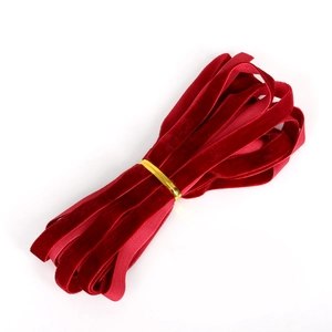 Detail of premium 10mm red velvet ribbon bundle with soft texture and golden binding tie