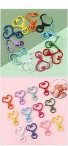 Close-up of colorful heart-shaped lobster clasps with spring gate and high-gloss finish