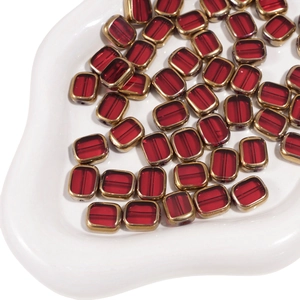 Macro shot of 10x12mm ruby red glass beads with vintage gold metal frame for DIY jewelry